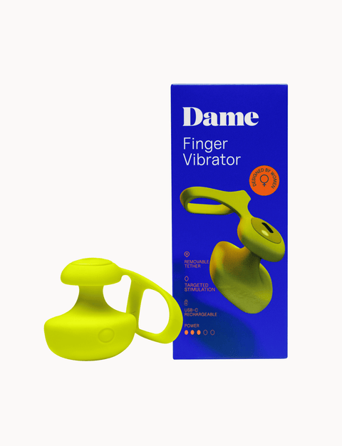 Yellow finger vibrator and its packaging with 'Dame' branding on a white background