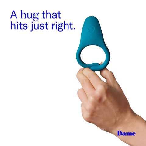 Blue c-ring held by a hand with text 'A hug that hits just right.' and brand name 'Dame' on a white background.