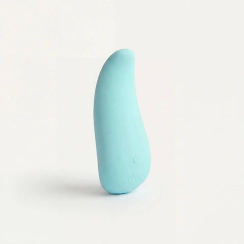 Turquoise-colored palm shaped personal massager on a light gray background