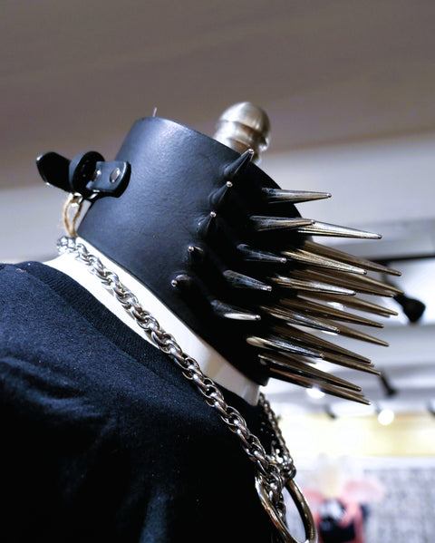 Black leather bracer with spikes and chain on a blurred background