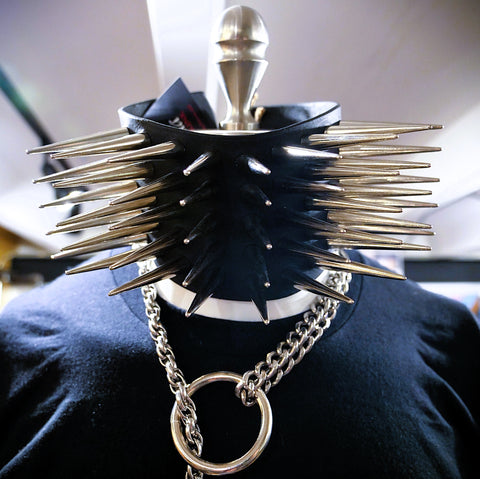 Black leather belt with metallic spikes and chain on a mannequin
