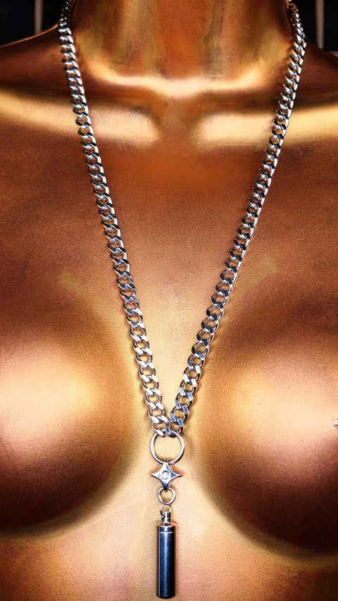 Mannequin torso with a steel chain necklace against a cage