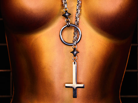 Silver necklace with a cross pendant on a mannequin