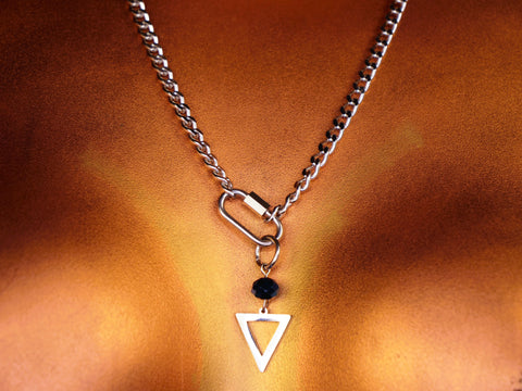 Necklace with a triangle pendant on a bronze background