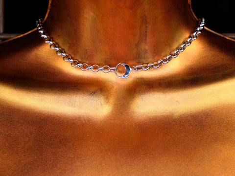 Silver chain necklace on a bronze surface