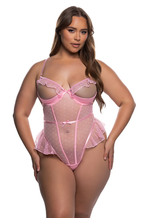 Plus size model wearing a pink ruffled lingerie set on a white background