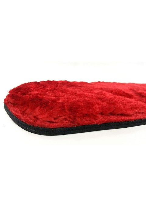 Close up of red faux fur paddle